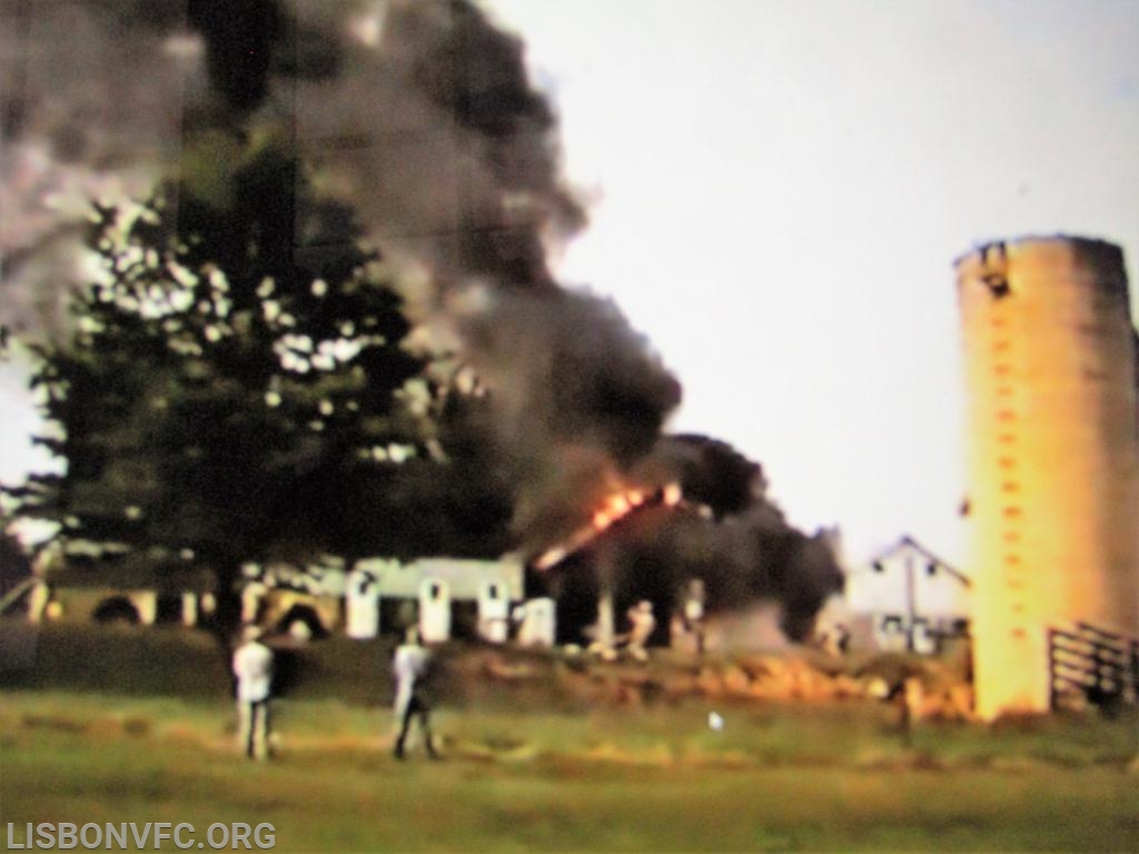 The point of this blurry photo is to show the fire from another angle, and to point out that shrapnel from the explosion went as far as the silo.