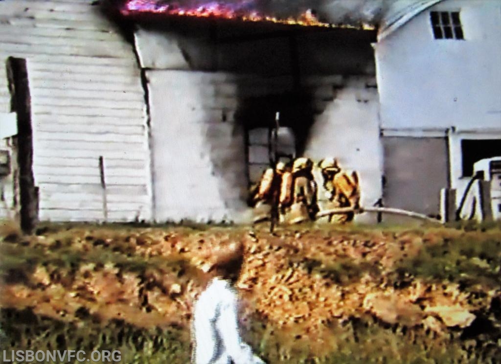 Fire is being knocked, again personnel standing in front of windows that explosion passed thru only minutes before. You can also see the 2nd barn that was an exposure as well.
